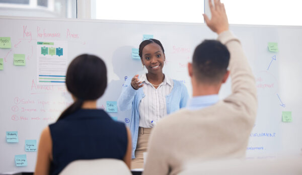 Shot of a businessman asking a question during a presentation.