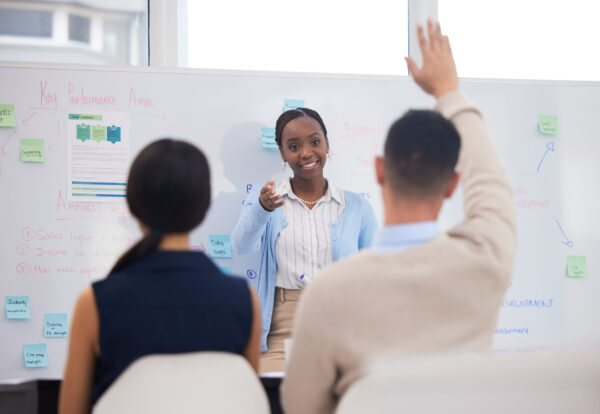 Shot of a businessman asking a question during a presentation.